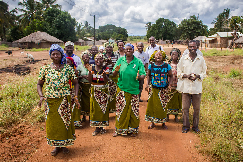 A group of people walk through the fields outside their village in Mozambique
