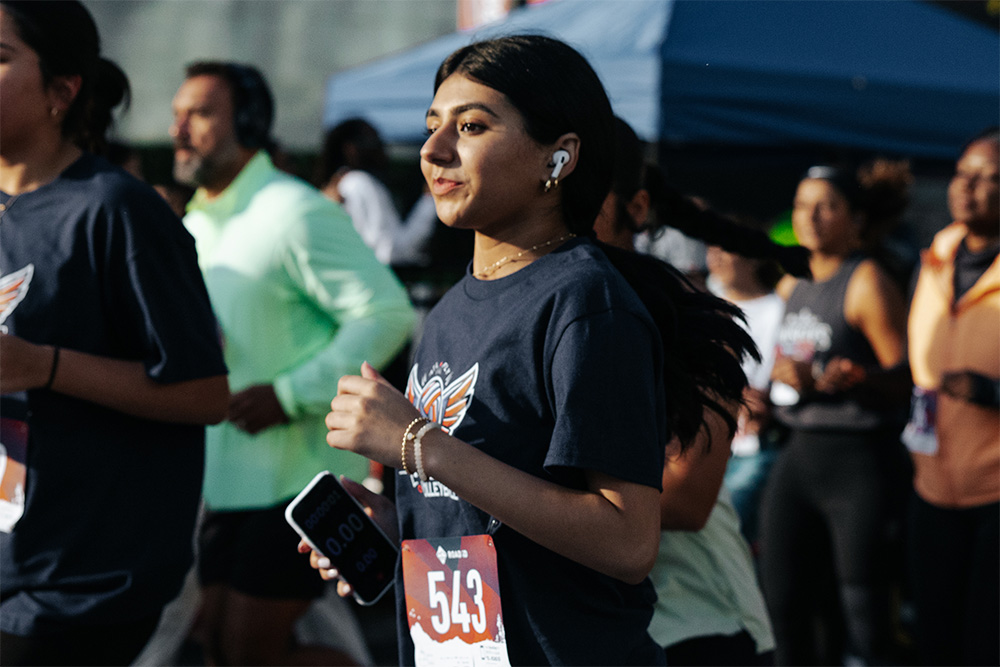 A young woman runs in the 2024 AKF USA Atlanta Walk & Run