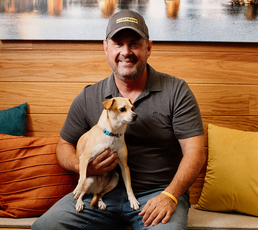 Man holding a small dog