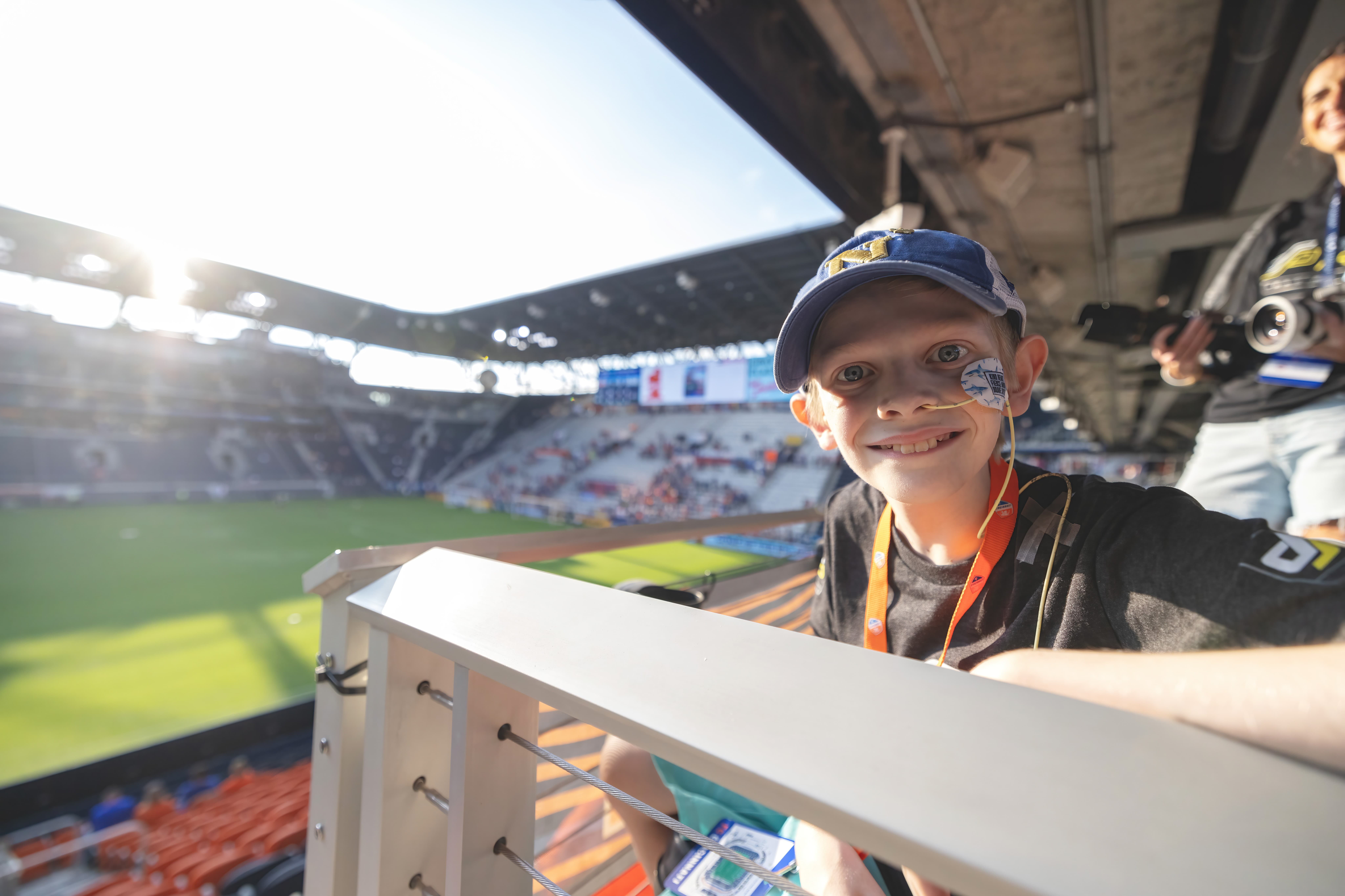 Child smiling to camera in the stands of stadium