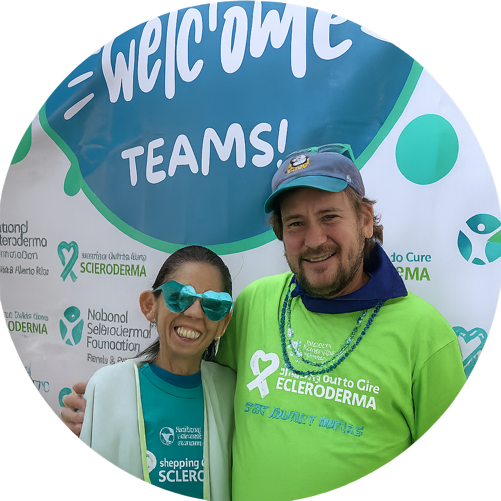 Woman and man with arms around shoulders standing in front of a welcome banner