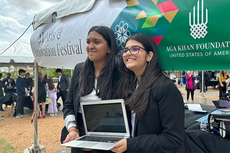 Young women hold their laptop presentation at the Youth Innovation Festival Young women hold their laptop presentation at the Youth Innovation Festival