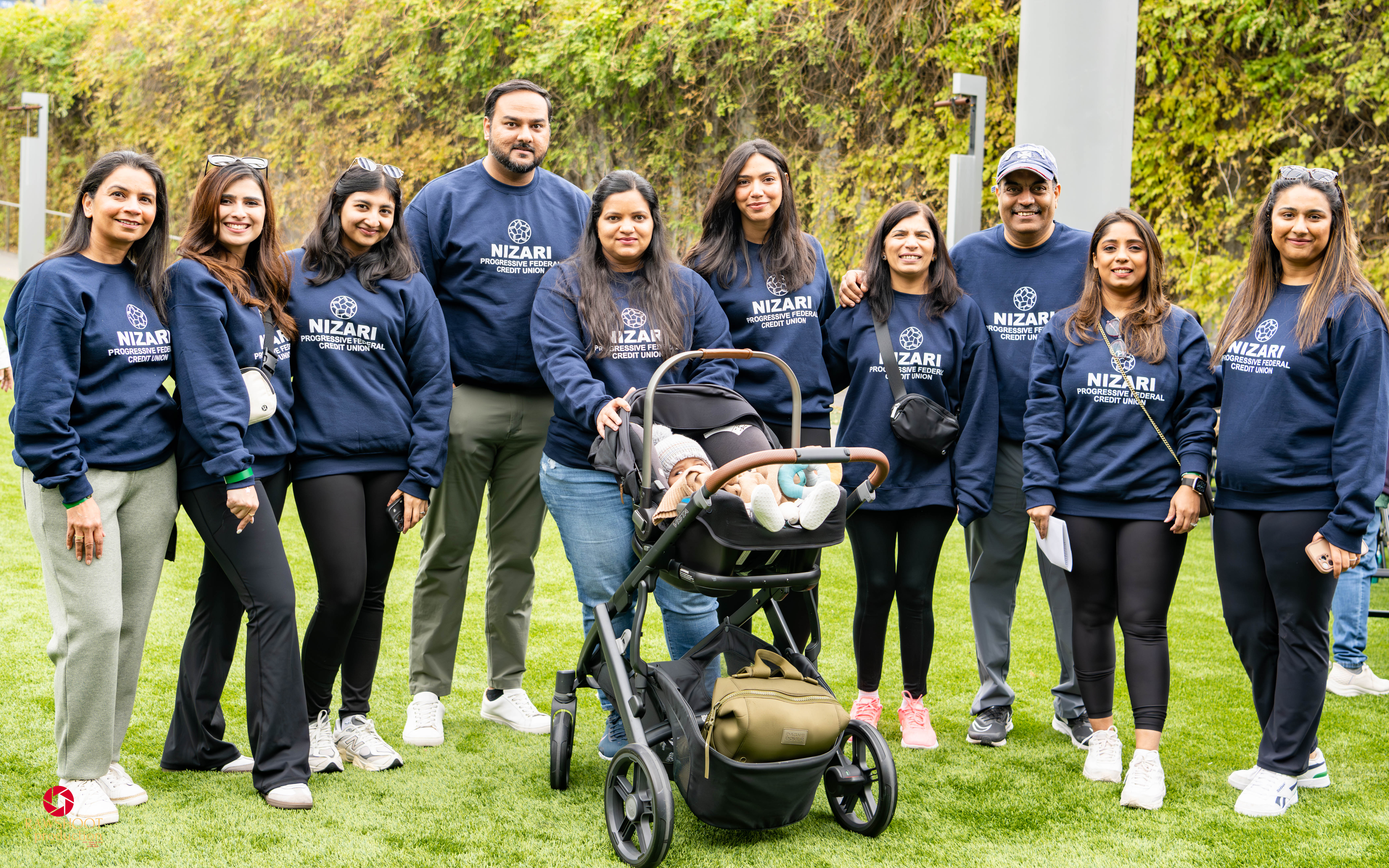 a group of people wearing Nizari Bank sweatshirts